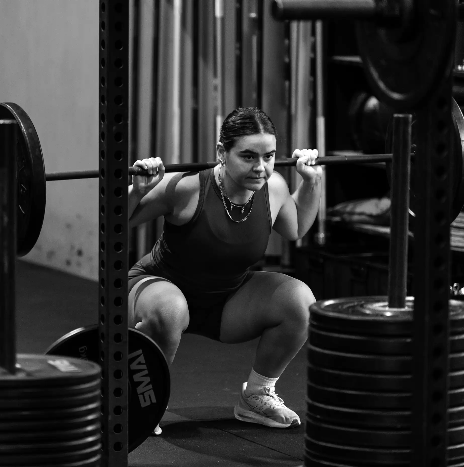 An athlete performing controlled dumbbell work during a BodyTone class